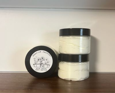 White body Lotion in clear plastic jar with black lid