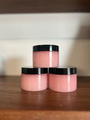 3 clear jars with pink sugar scrub and black lid