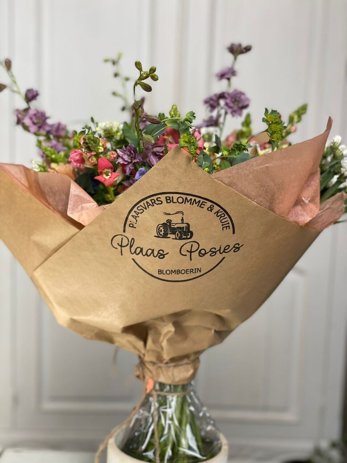 Stamp on brown paper around a bunch of flowers