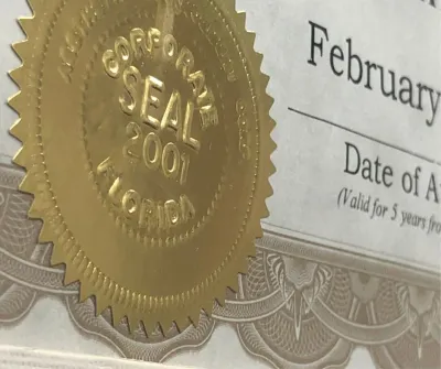 Desktop embosser for creating raised seal impressions on paper