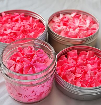 Four containers of All Smells Better in Pink whipped soap, displaying a vibrant neon pink, fluffy texture. The soap is packaged in both glass jars and metal tins