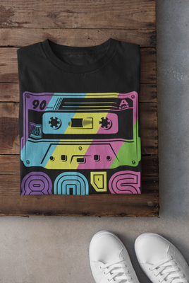 Black 80s Vibe Retro Cassette T-Shirt with neon rainbow design on dark background.