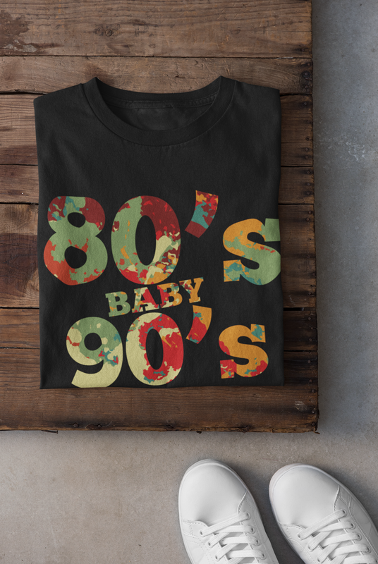 80s Baby 90s Made Me Retro Graphic T-Shirt Folded in a Wooden table