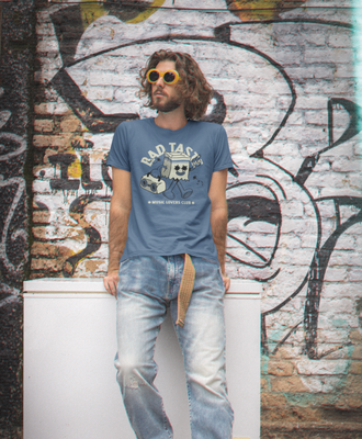 BAD TASTE Funny Retro DTF Transfer blue graphic t-shirt on man with long hair.