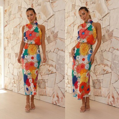 Woman in FargeFest midi dress with floral print, radiating with vibrant colors