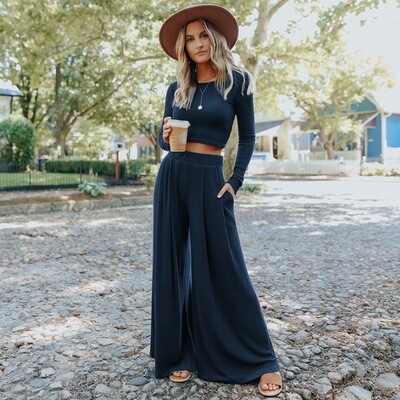 Woman in EleganceMaxi maxisuit in navy blue, radiating relaxed elegance