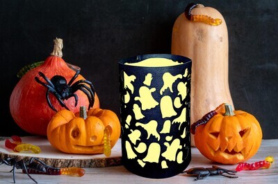 Black paper lantern with cutout images of ghosts all around a pillar LED Candle.