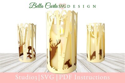 LED pillar candle sleeve-style lantern featuring a Birch Forest and a family of Deer peeking through the woods. 