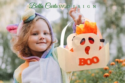 Halloween treat basket in the shape of a spooky white ghost being held by a little girl trick-or-treater, made with a 3D SVG file from Bella Carta Design and a Cricut.