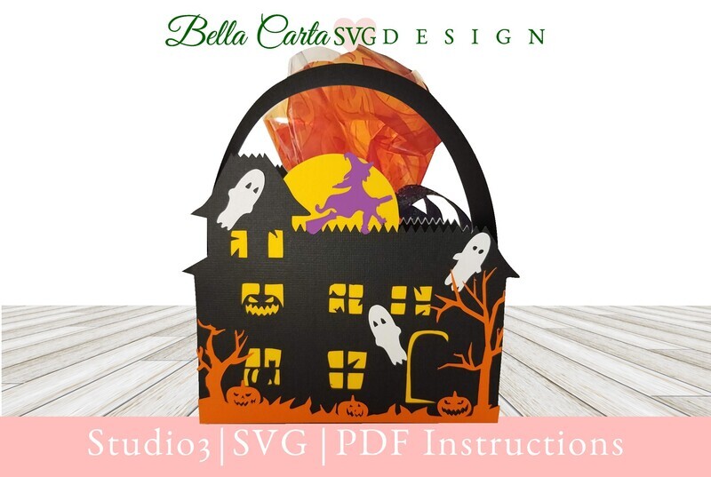 Halloween House basket crafted with a Cricut and an SVG template featuring a haunted house surrounded by playful ghosts , jack-o’lantern pumpkins, spooky trees, and a witch flying across the full moon.