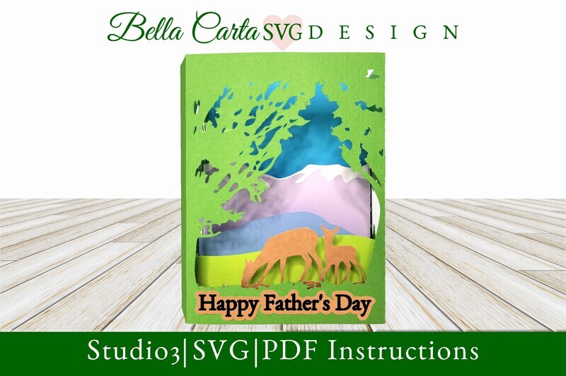 Create a unique 3D card for Father’s Day with this layered SVG shadowbox template  The card Depicts a Deer and Fawn among green trees set against a background of lavender mountains.