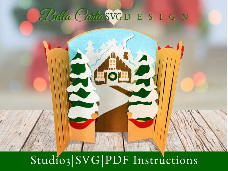 Christmas Card 3D SVG template for Cricut and Silhouette depicting gates that open to reveal a snow-covered cottage nestled in a winter forest.