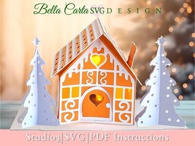 Finished 3D SVG Cricut project of a pop-up gingerbread house decorated with intricate &quot;icing&quot; details and an LED tealight inside the door to make it glow.  This decoration is part of the Christmas Treat Village set by Bella Carta Design.