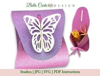 Small gift box for jewelry, candy, and other small gifts featuring an intricately cut butterfly closure on the top, made with a 3D SVG and a Cricut, Silhouette or other cutting machine.. The template allows you to craft a 3-inch wide by 3.5-inch deep by 2.5-inch tall gift box, perfect for presenting a gift for Mother&#39;s Day or a birthday.  This picture shows the box made from one-sided purple and pink glitter paper.