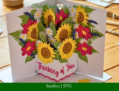 3D pop up card opening to reveal layered paper sunflower bouquet in a white vase