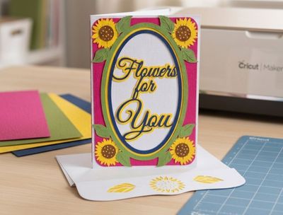 Handmade yellow sunflower pop up card folded flat on light background
