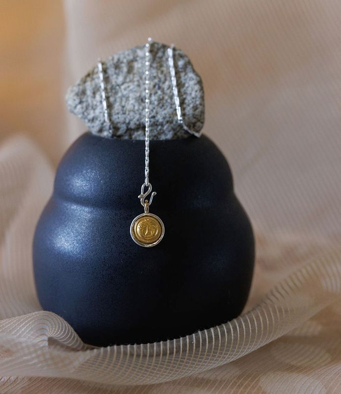 Surya with Gold Face Amulet
