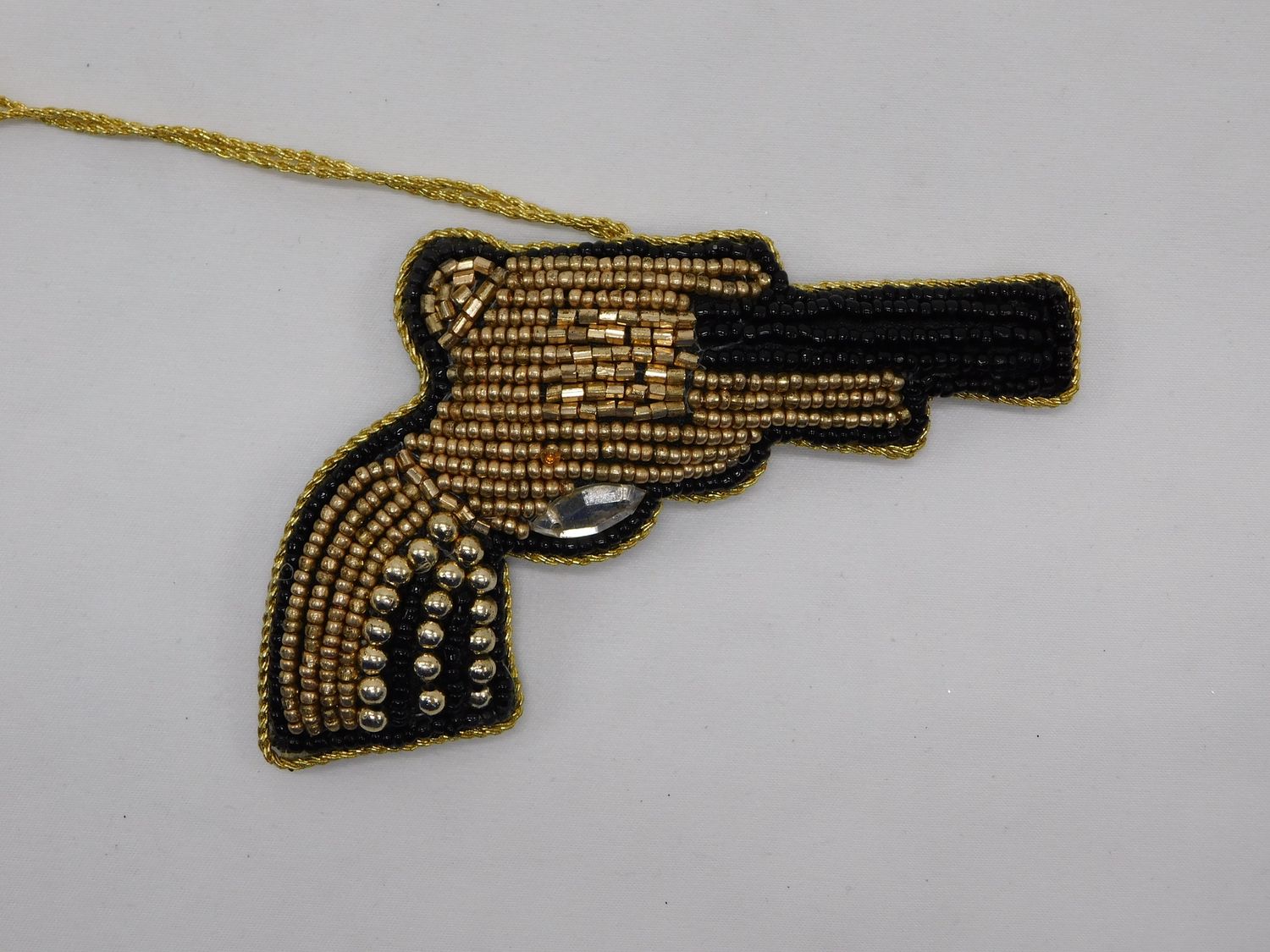 goud zwart kralen pistool
