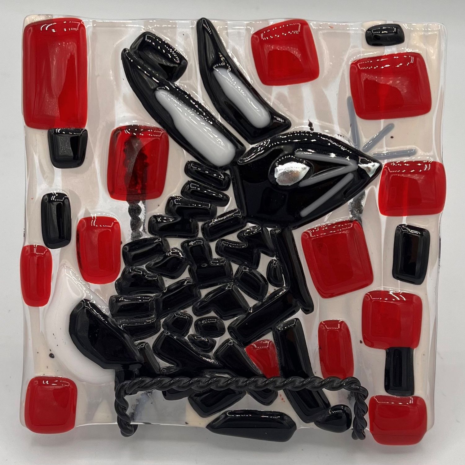 Alphonso Rowe, Fused Glass Stand Piece, Black Rabbit on Red, White and black Background