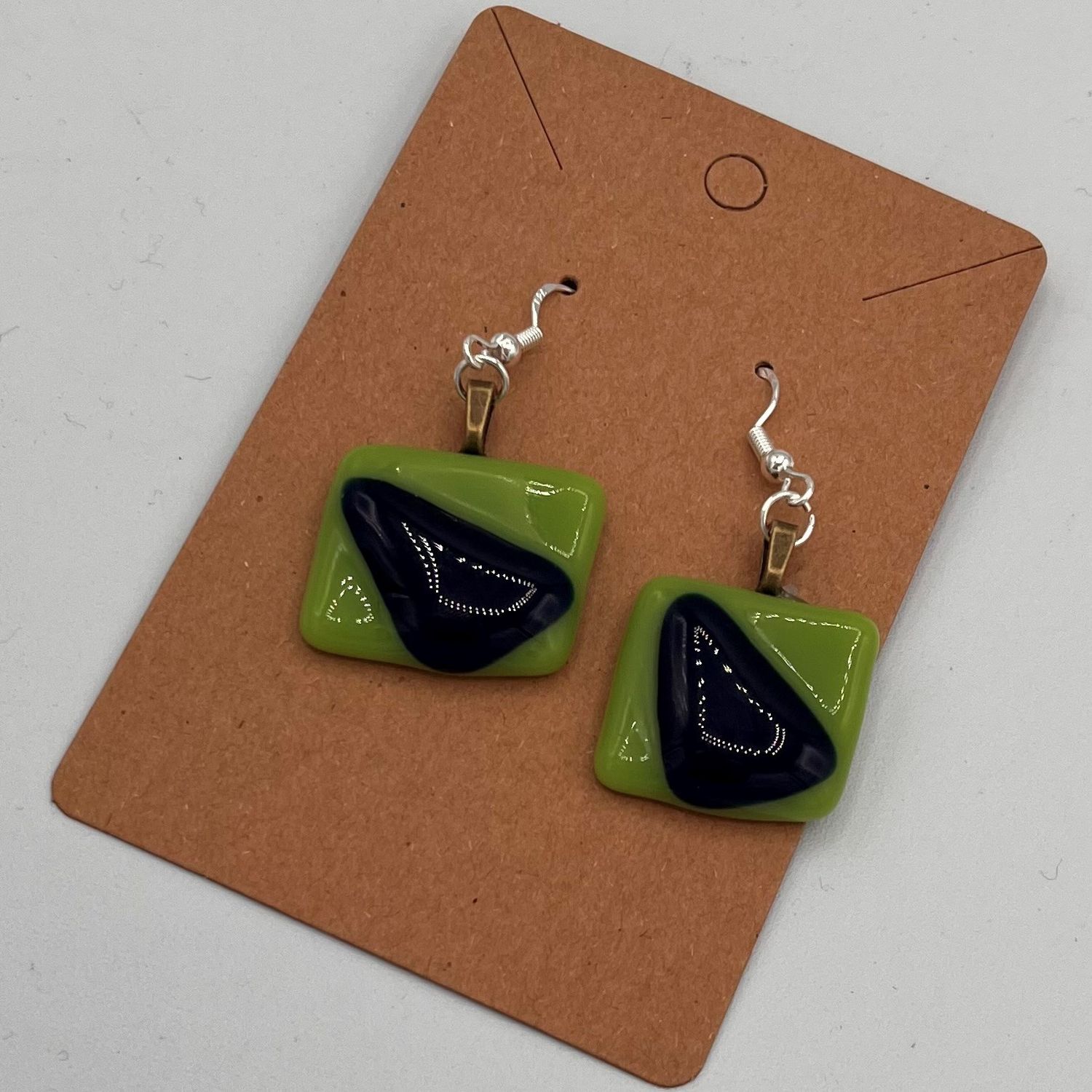 Alphonso Rowe, Fused Glass Earrings, Black Triangles on Green Background