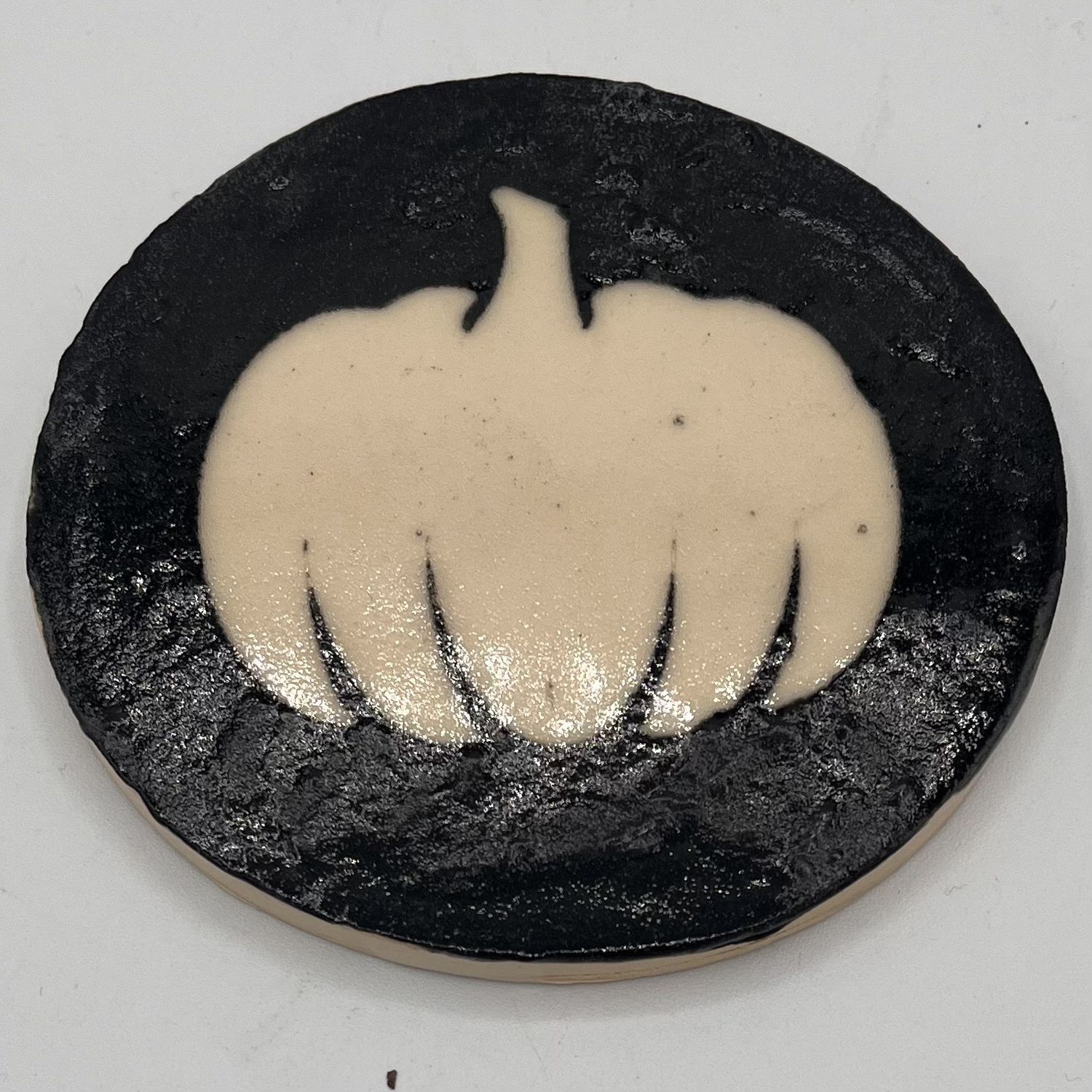Tammy McCammon, Ceramic Coaster. Pumpkin on Black Background