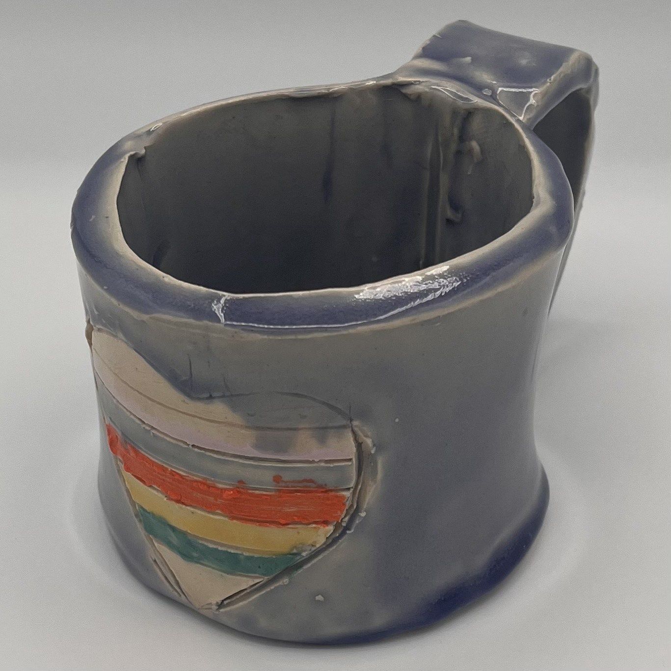 Tammy McCammon, Ceramic Mug, Rainbow Striped Heart on Blue Background