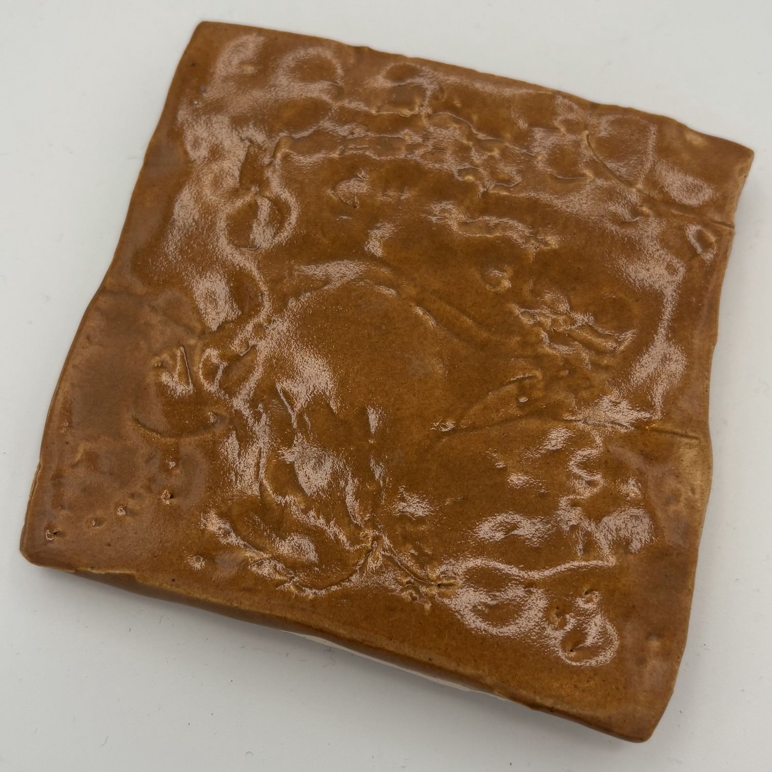 Breanna Allmandinger, Ceramic Coaster, Yellowish-Brown Design