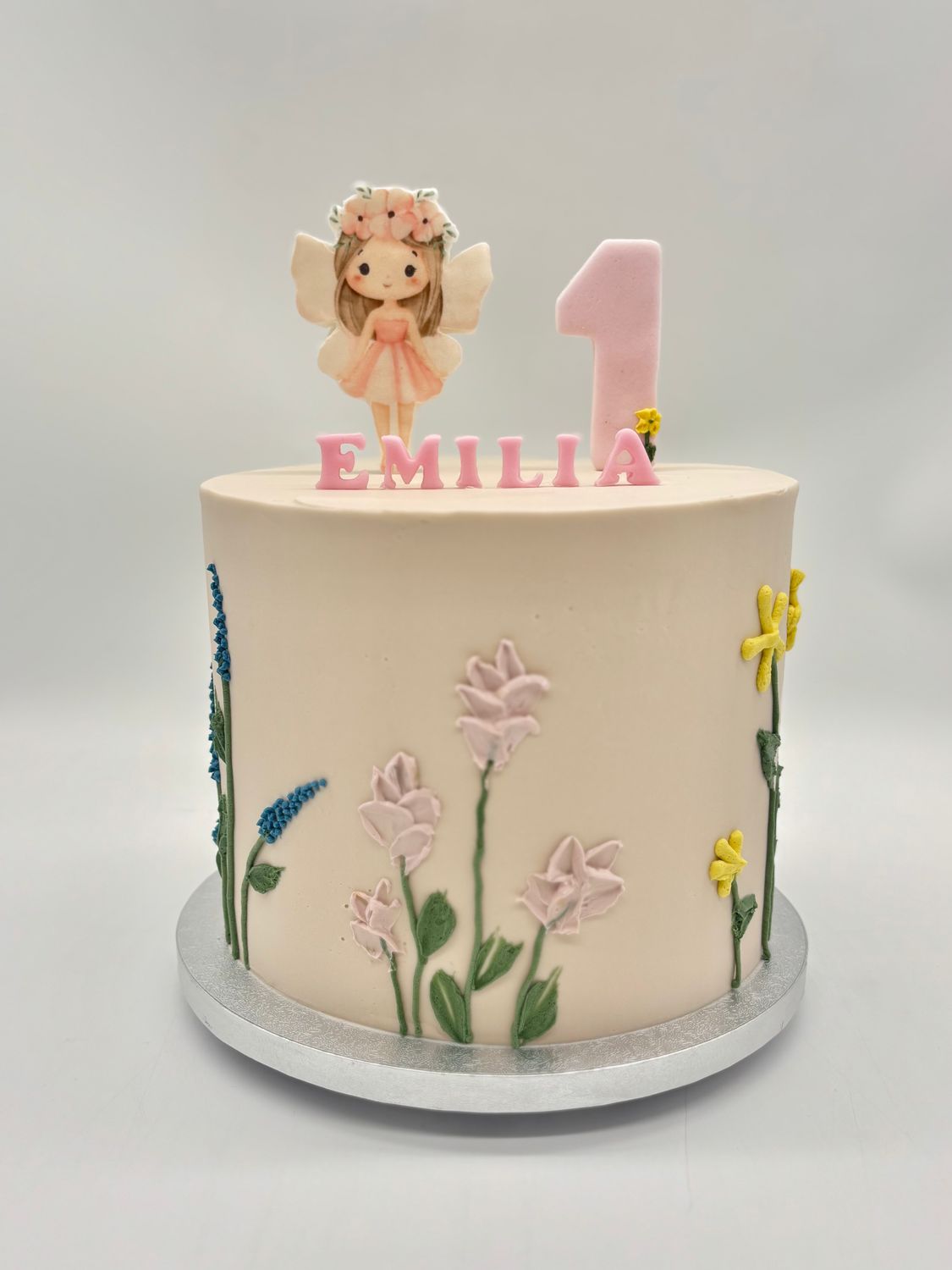 Torte mit Cremeblumen und Fee