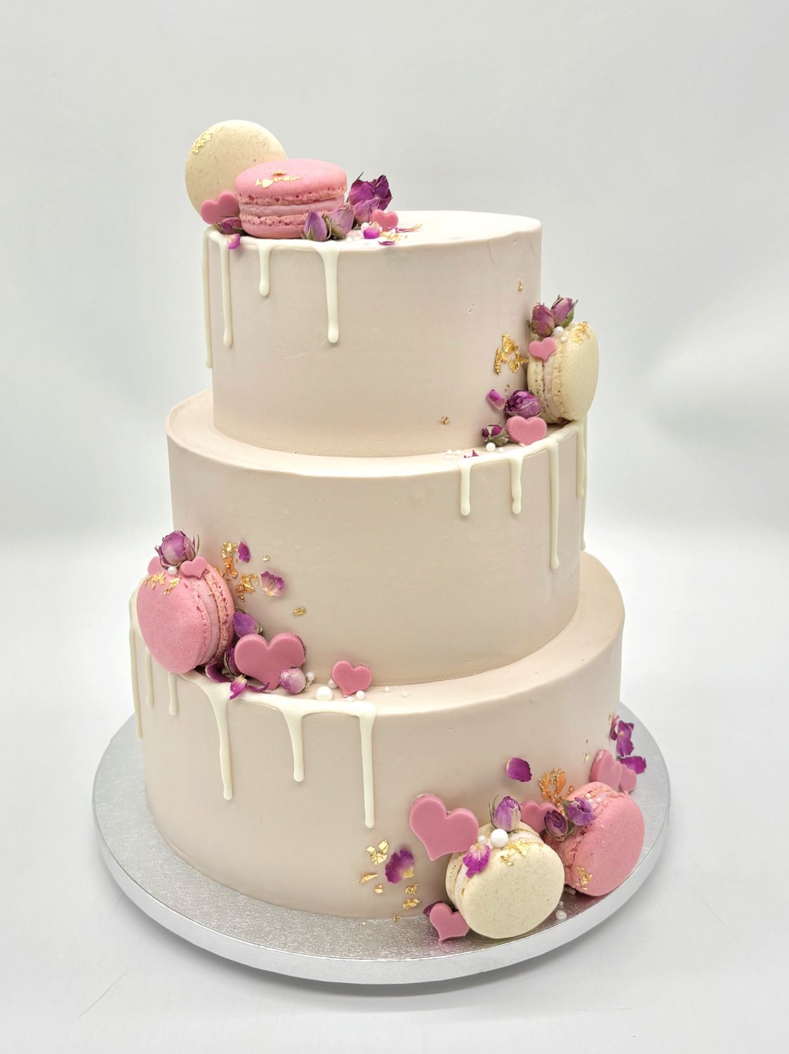 Torte mit Drip, Macarons, Herzen und essbaren Blüten (dreistöckig)