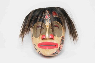 NORTHWEST INDIAN STYLE MASK WITH RAVEN ON FACE IN NATURAL COLOR WITH HAIR OR WITHOUT. HAND CARVED AND PAINTED ALBESIA WOOD. 26346