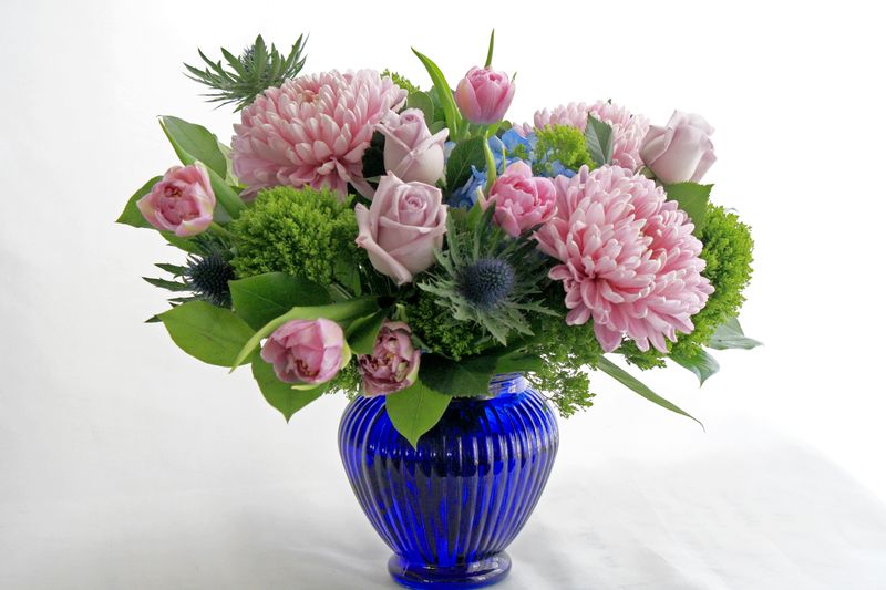 Mandala Floral, Calgary flower shop. Blue and purple flowers in blue glass vase. Delivery available for Calgary, Okotoks, Chestermere, Airdrie.