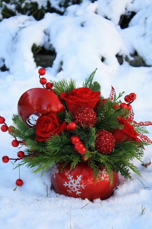 Christmas arrangement with red roses, red berries, in christmas ornament. delivery and pickup available in Calgary from Mandala Floral Inc.