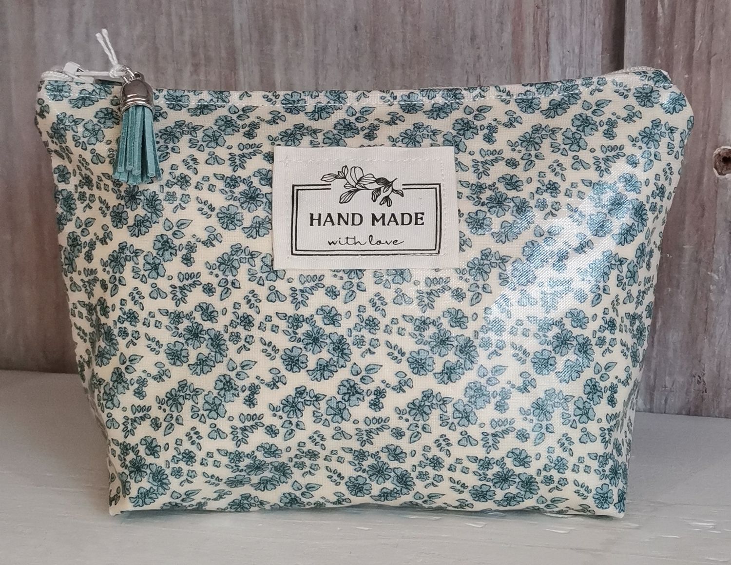 Trousse à maquillage à  fleurs blanches et bleues