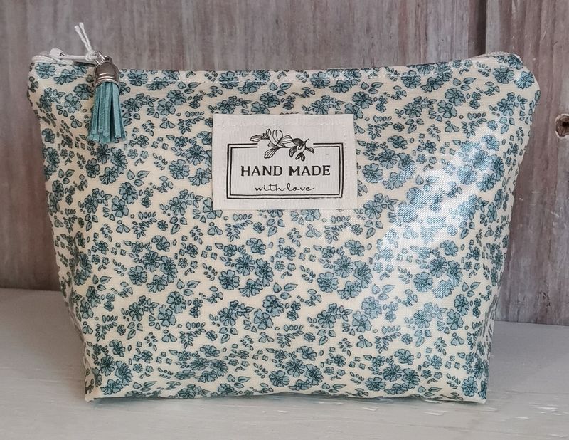 Trousse à maquillage à  fleurs blanches et bleues