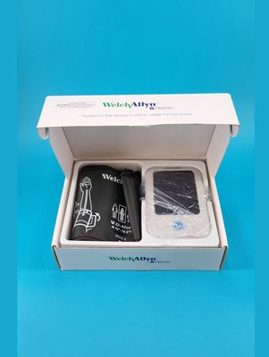 Open box displaying the monitor and the arm cuff.