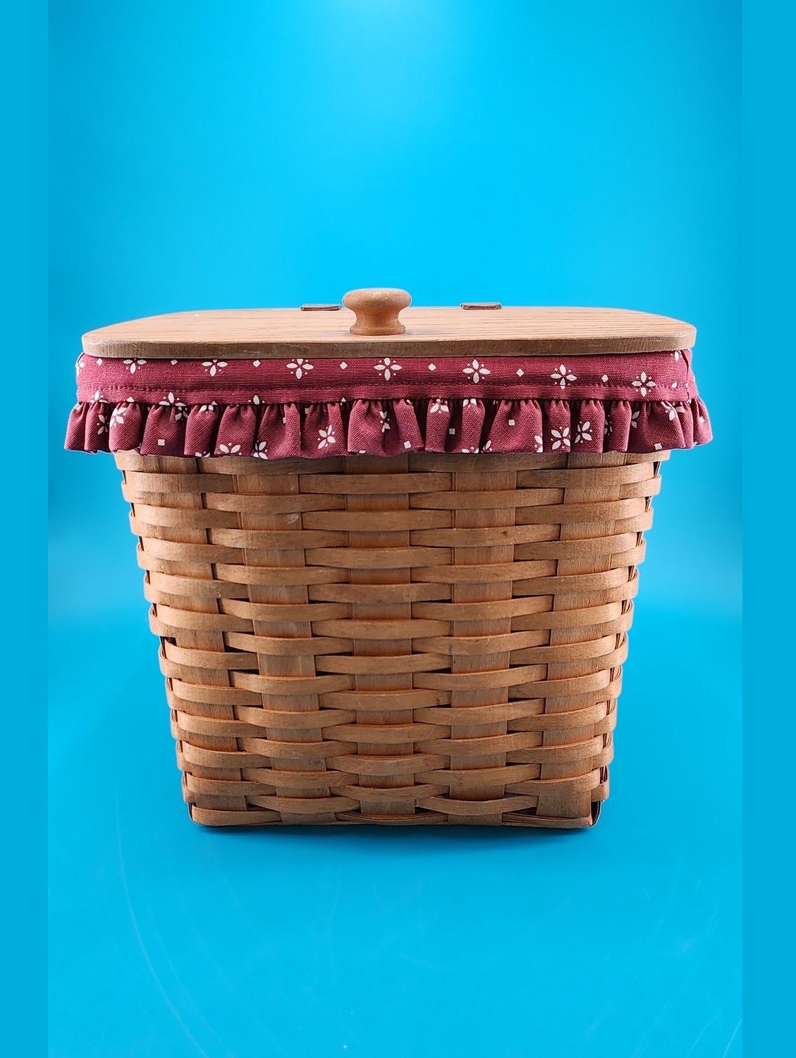 Front view showcases the basket's red ruffle lining.