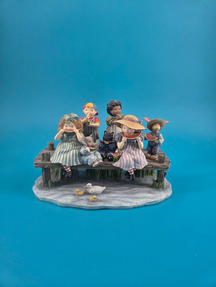Figurine features four children and three anthropomorphic animals.