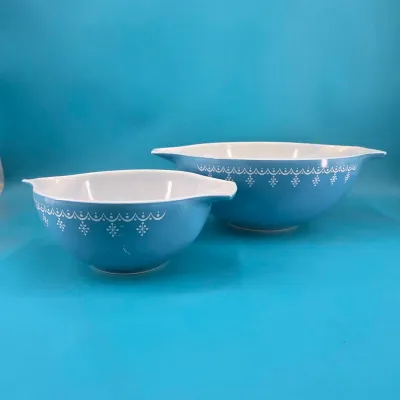 Bowls are a light blue base with white snowflake pattern running along under the rim.
