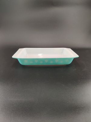 Vintage PYREX Turquoise Snowflake Casserole Dish Two alternating snowflakes line the turquoise side of the dish.