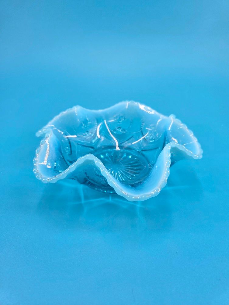 Northwood Blue Opalescent Glass (Jewel Heart) The bowl edge is scalloped and has six large ruffles.