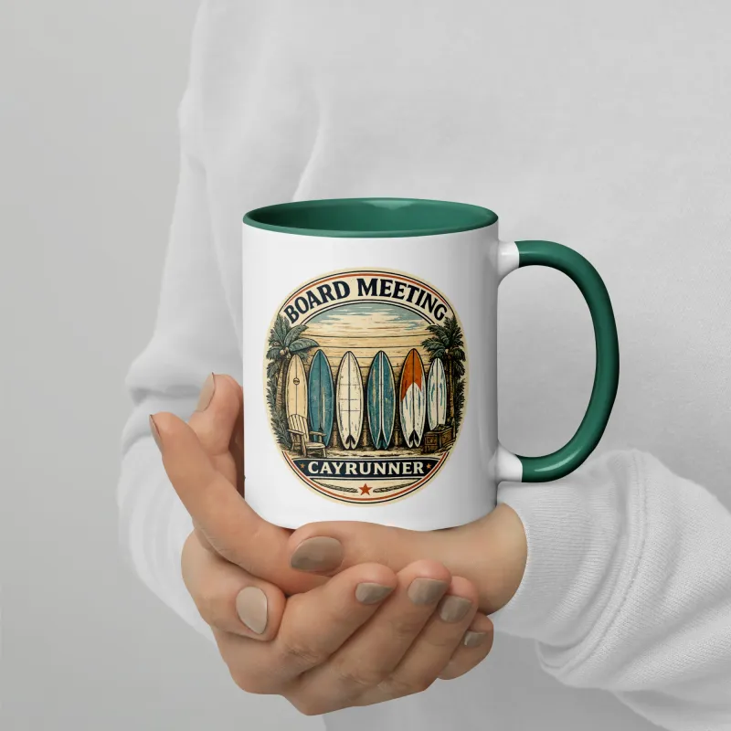Hands holding Cayrunner Board Meeting Coffee Mug with dark green handle, showing surfboard beach graphic design.