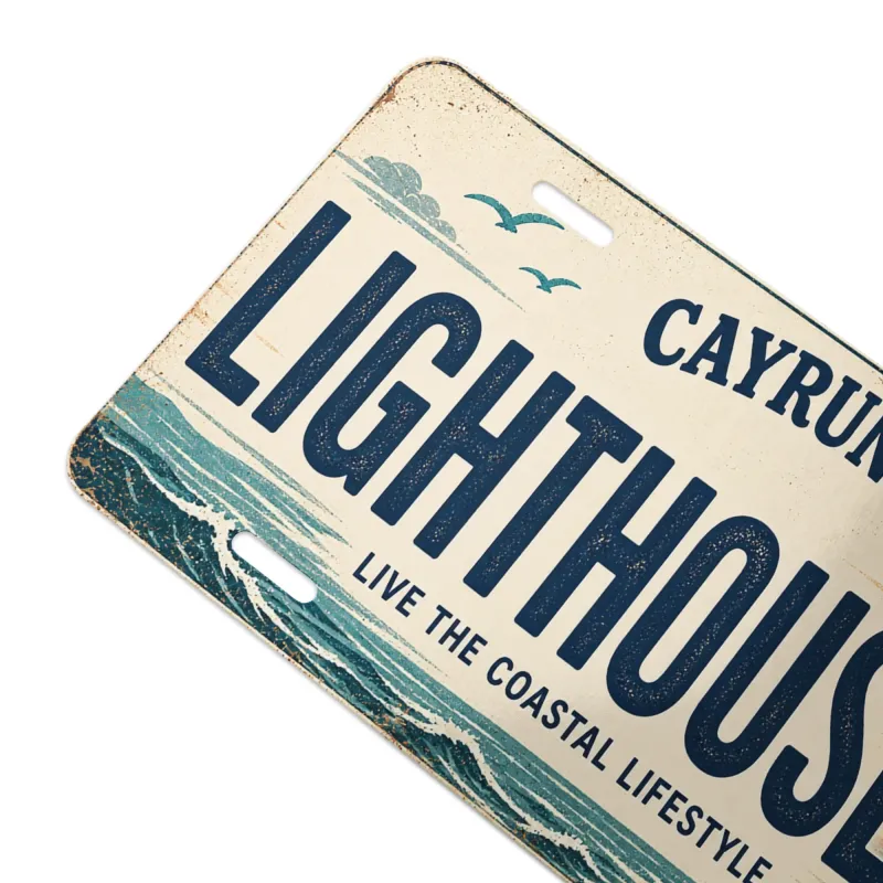 Close-up angled view of Cayrunner Lighthouse Vanity License Plate, showing ocean waves and seagulls artwork.
