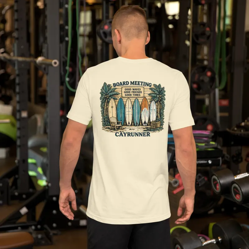 Man in a gym wearing the Cayrunner Board Meeting Unisex T-Shirt, natural color, showing back surfboard design