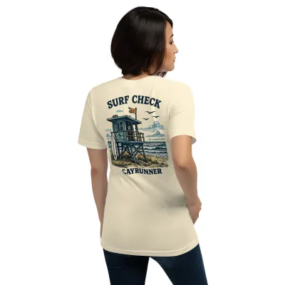 Woman wearing the Cayrunner Surf Check Unisex T-Shirt in natural, showing back lifeguard tower design