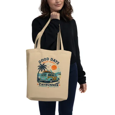 Woman carrying the Cayrunner Good Days Salty Ways organic cotton tote bag with beach wagon design