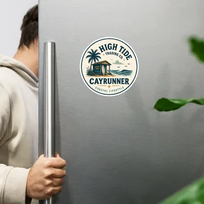 Cayrunner High Tide Trading Co. flexible magnet on a stainless steel refrigerator, person opening fridge door nearby.
