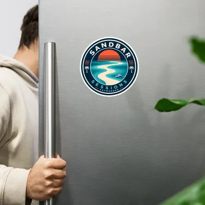 Cayrunner Sandbar Sessions flexible magnet on a stainless steel refrigerator, person opening fridge door nearby.