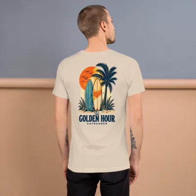 Man wearing Cayrunner Sunset Boards unisex t-shirt in soft cream, back view showing "Golden Hour" surfboard design.