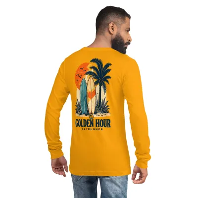 Man wearing Cayrunner Sunset Boards unisex long sleeve tee in gold, back view showing "Golden Hour" surfboard design.