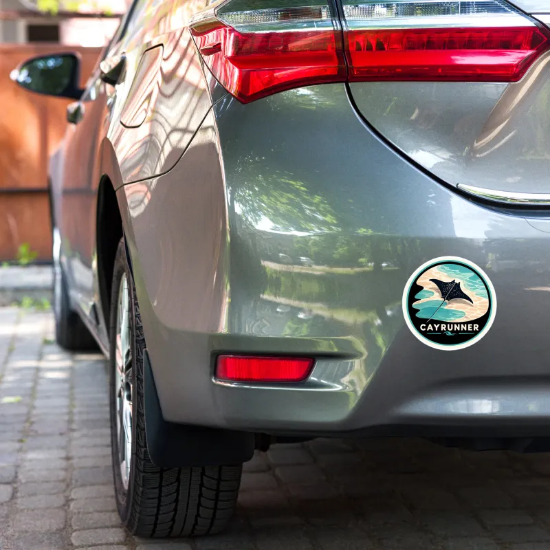 Cayrunner Silent Glide sticker with manta ray design applied to the rear bumper of a gray car.